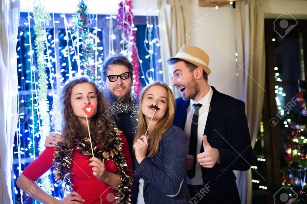 beautiful-hipster-friends-with-photobooth-props-celebrating-the-end-of-the-year-having-party-on-new-year
